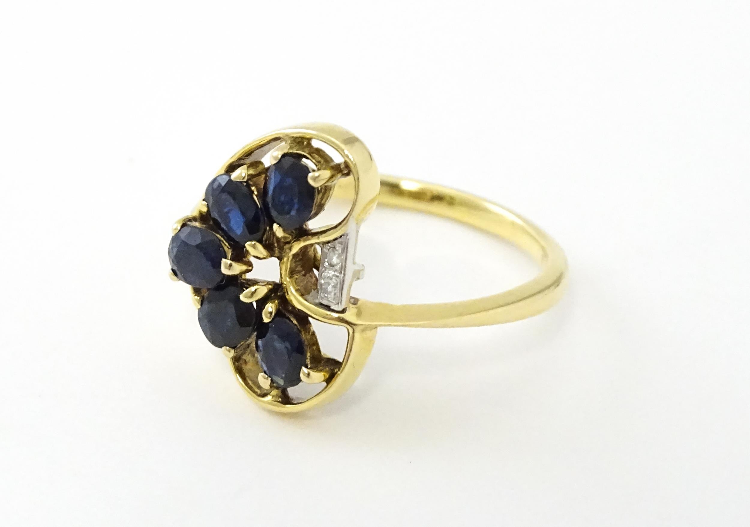 A 9ct gold ring set with 5 graduated blue spinel and two diamonds. Ring size approx. L 1/2 Please - Image 4 of 7