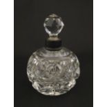A cut glass scent / perfume bottle with silver top hallmarked London C.1933 . Approx. 5 1/4" high