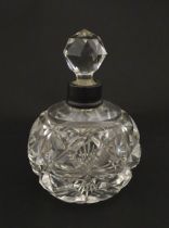A cut glass scent / perfume bottle with silver top hallmarked London C.1933 . Approx. 5 1/4" high
