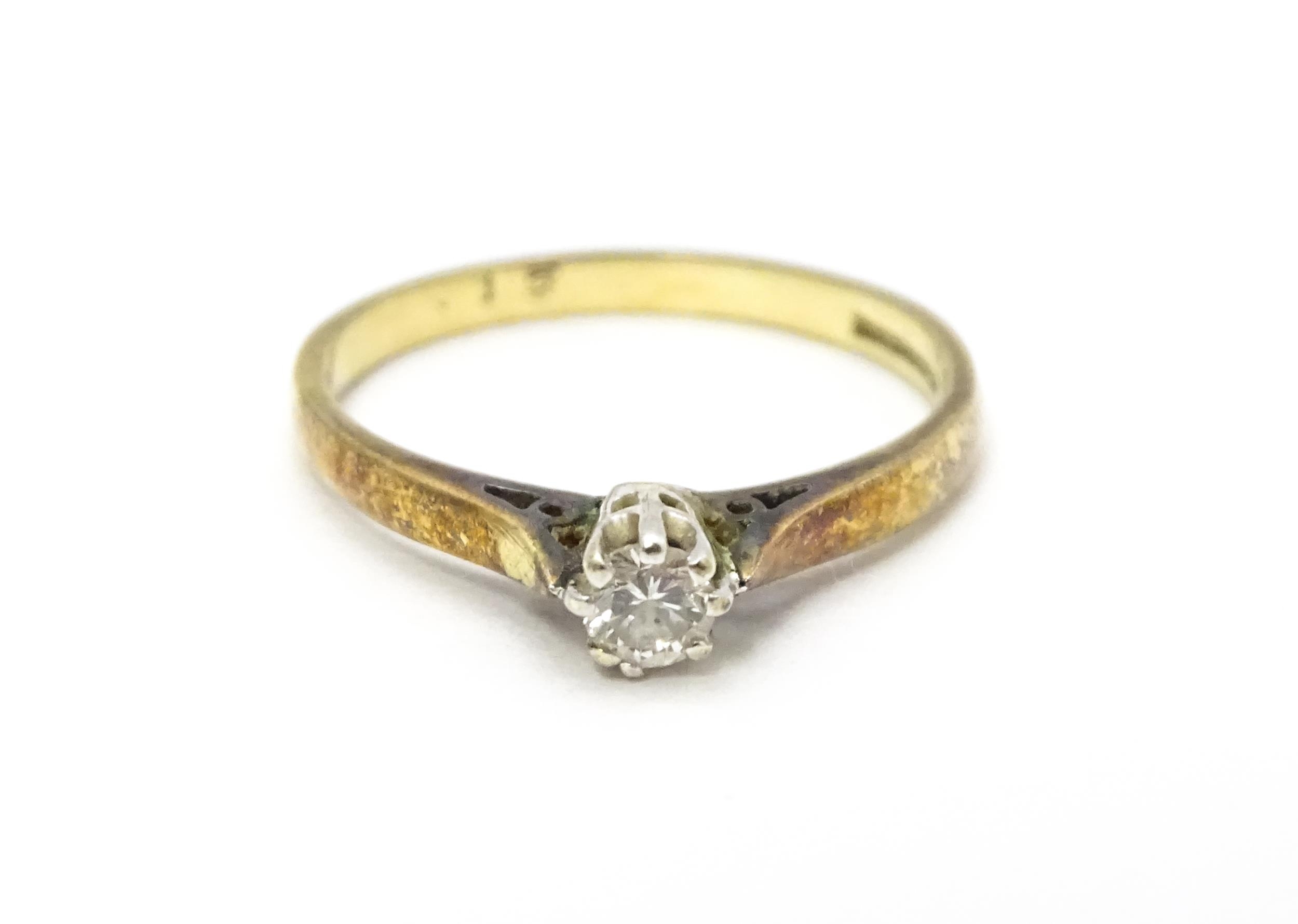 A 9ct gold ring set with diamond solitaire. Ring size approx. L 1/2 Please Note - we do not make