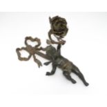 A cast bronze wall light sconce modelled as a cherub holding aloft a scrolling flower. Approx. 12"