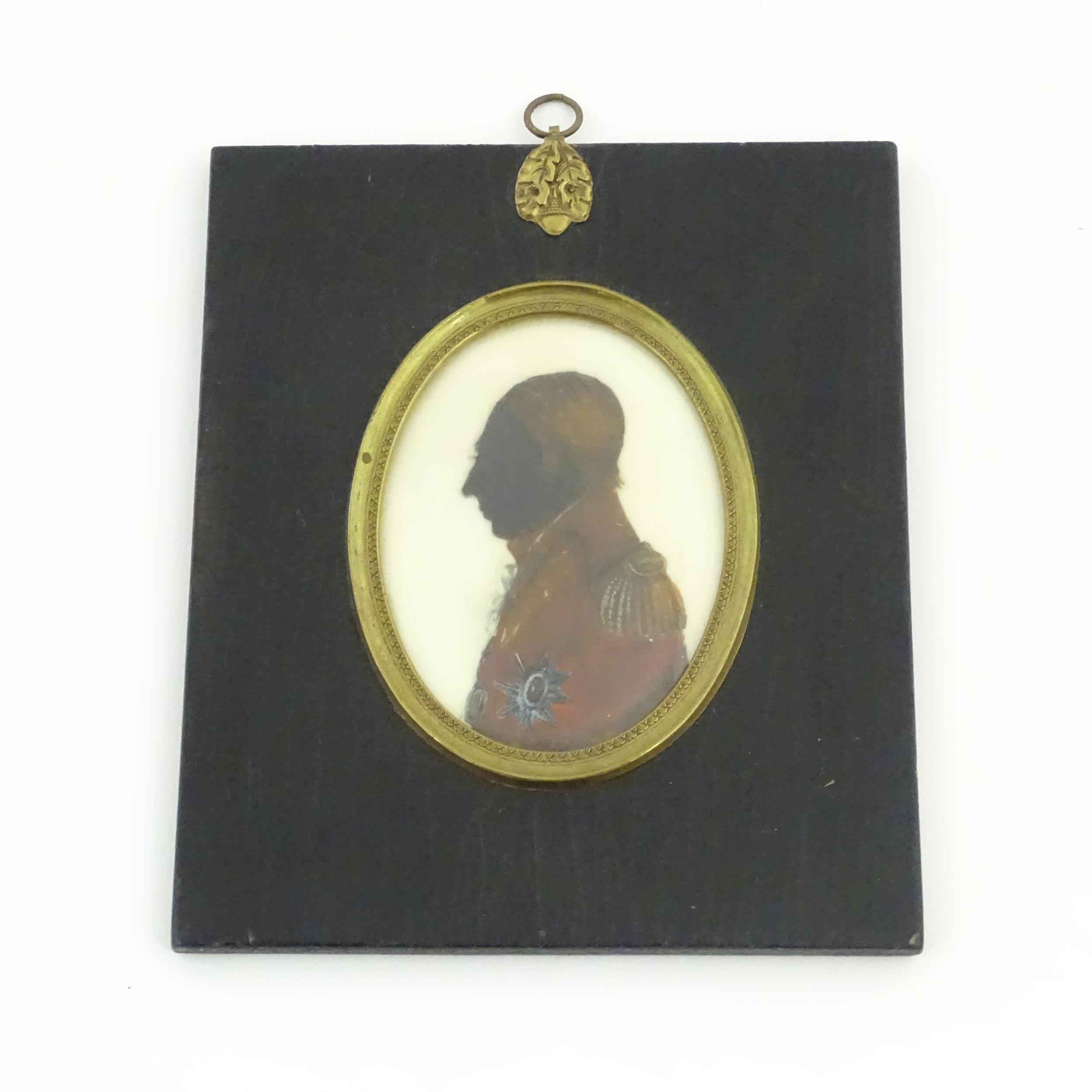 A 19thC watercolour silhouette portrait miniature depicting a a gentleman in profile and wearing