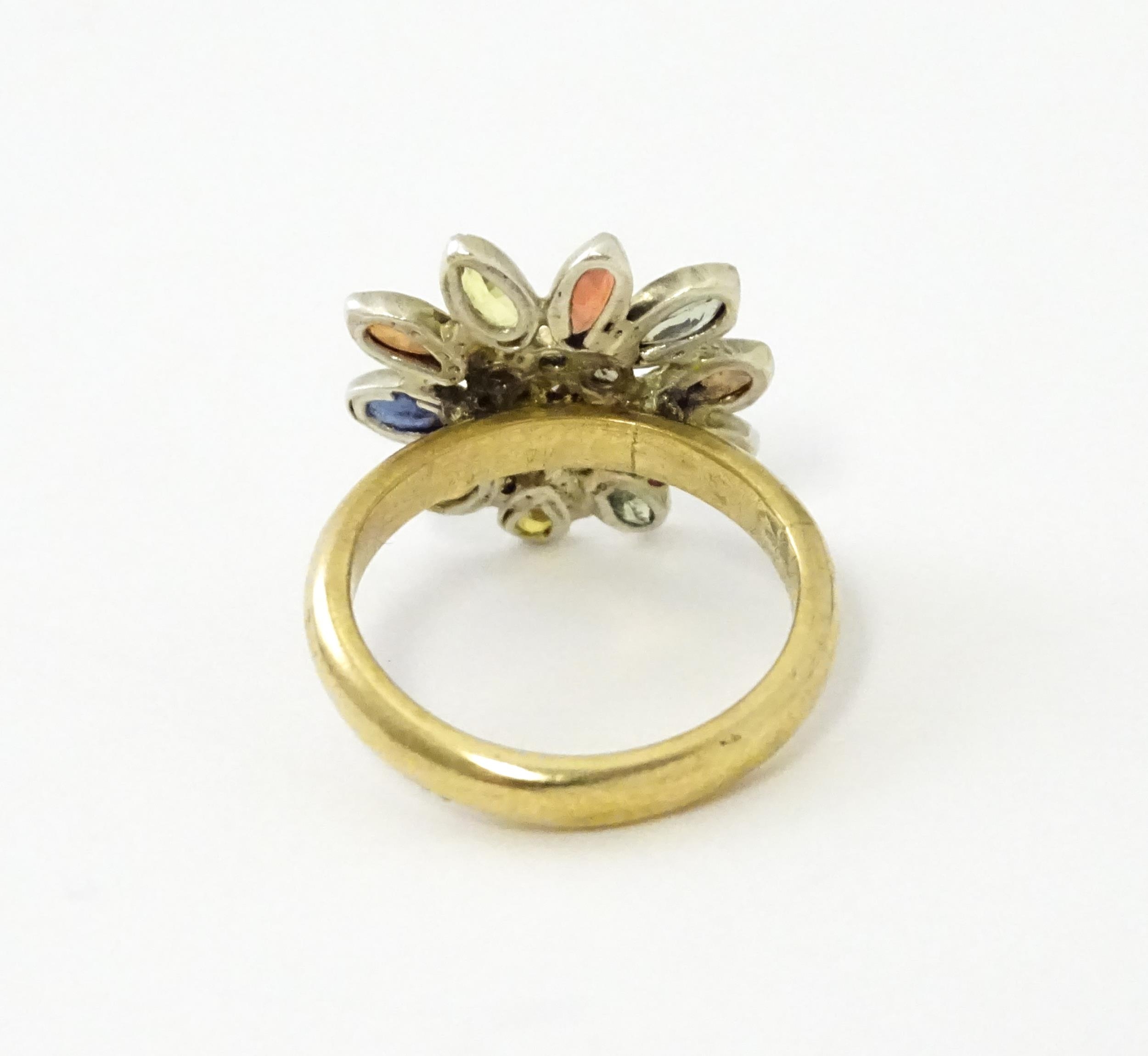 A 9ct gold ring set with central diamonds bordered by various coloured stones in a flower setting. - Image 6 of 6