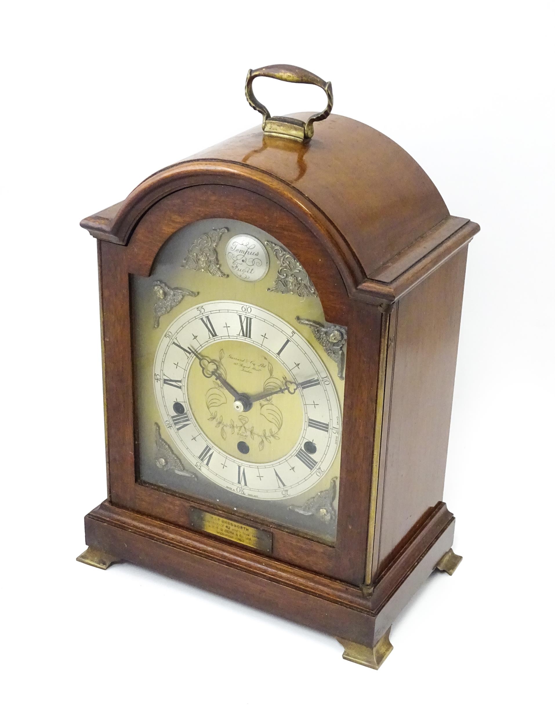 A 20th century mahogany cased Elliott 8-day chiming mantel clock, retailed by Garrard & Co of