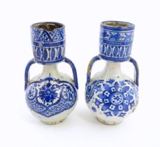 Two blue and white oil jars / berrada style vases with twin handles, decorated with brushwork