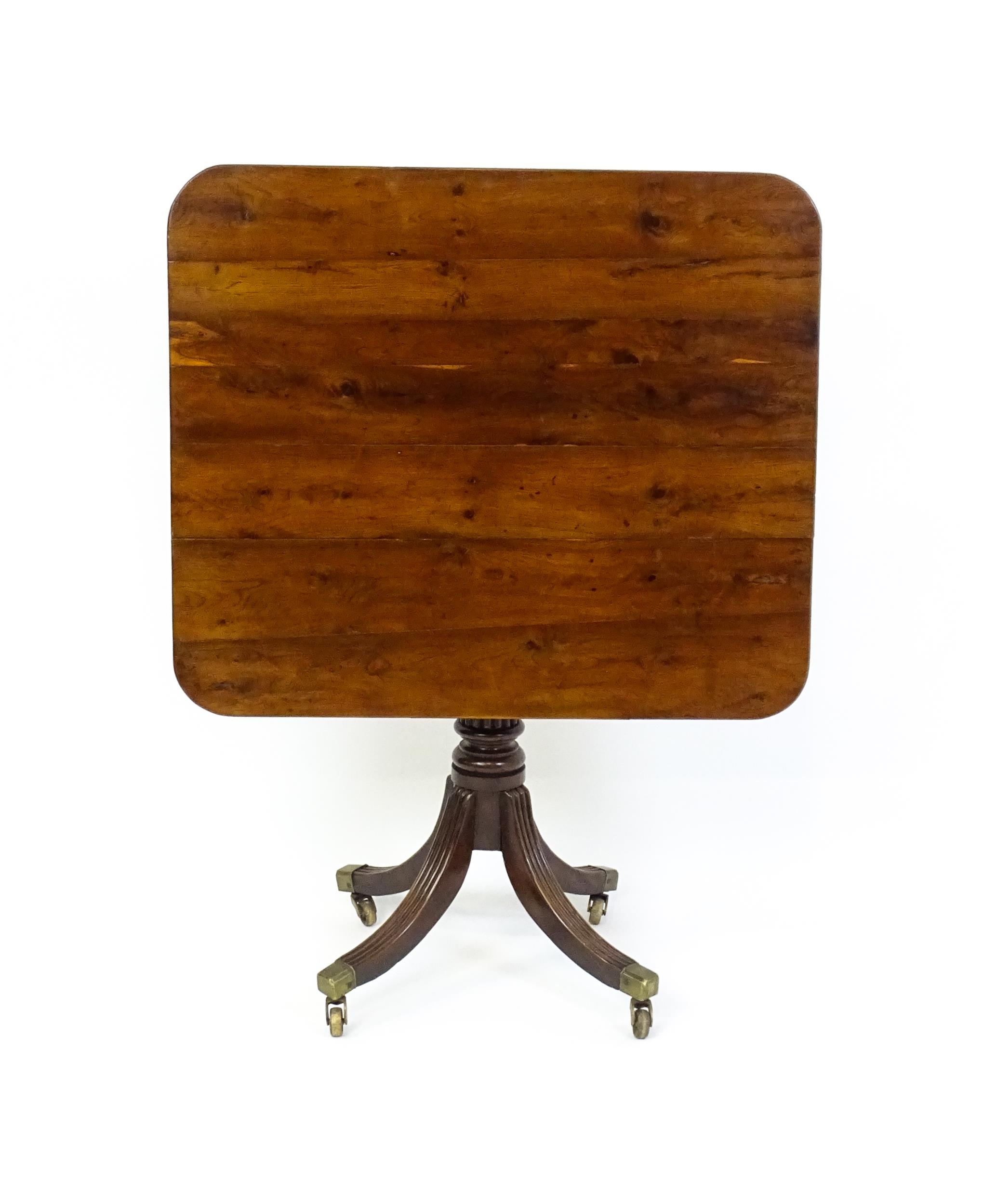 A 19thC tilt top occasional table with yew wood planked top above a reeded mahogany pedestal and - Image 3 of 13