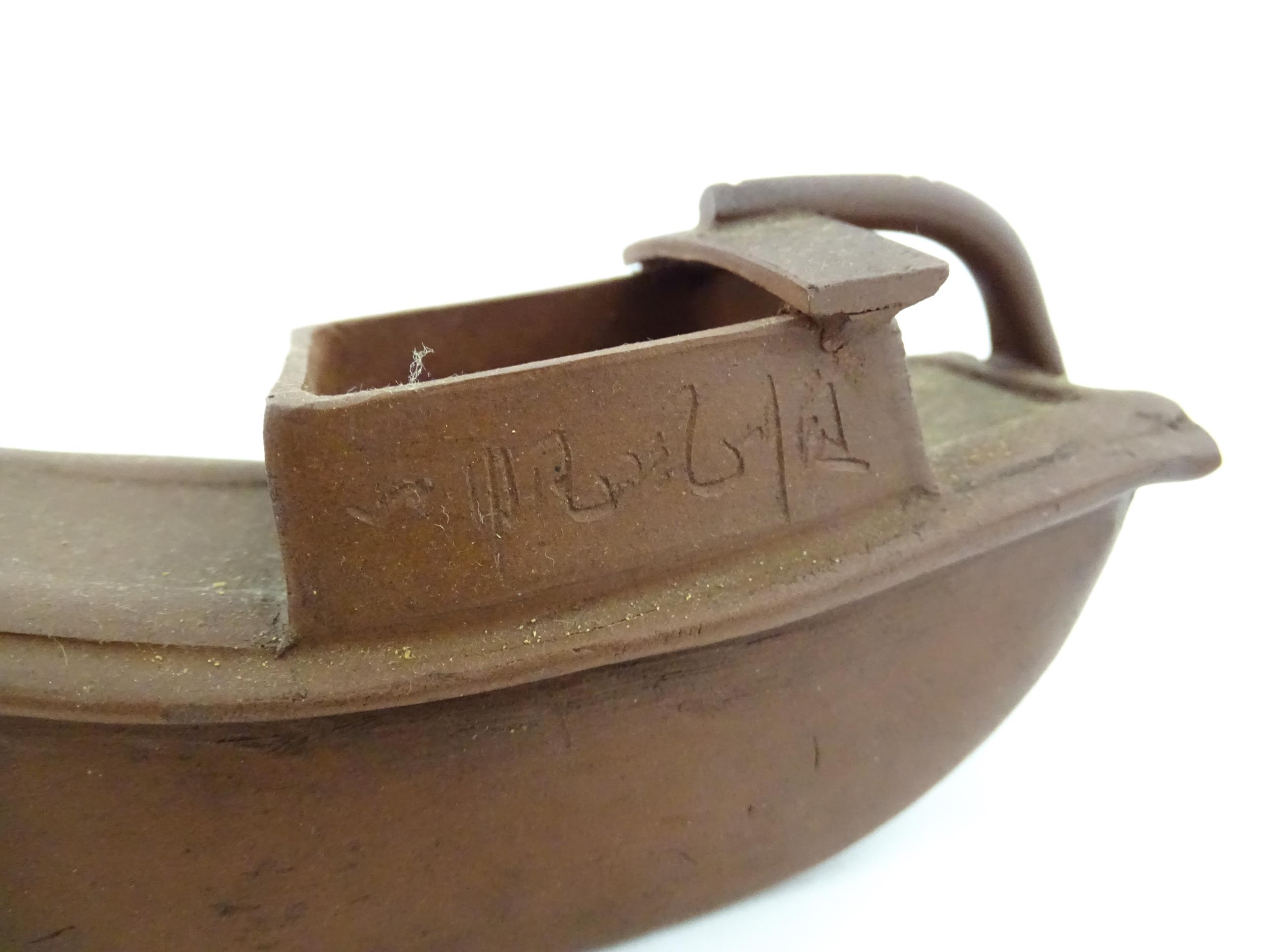 A Chinese Yixing teapot modelled as a boat with incised Character marks and Character seal under. - Image 3 of 8