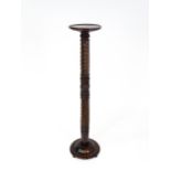 A Victorian mahogany torchiere / jardinière stand with a twist turned pedestal with carved