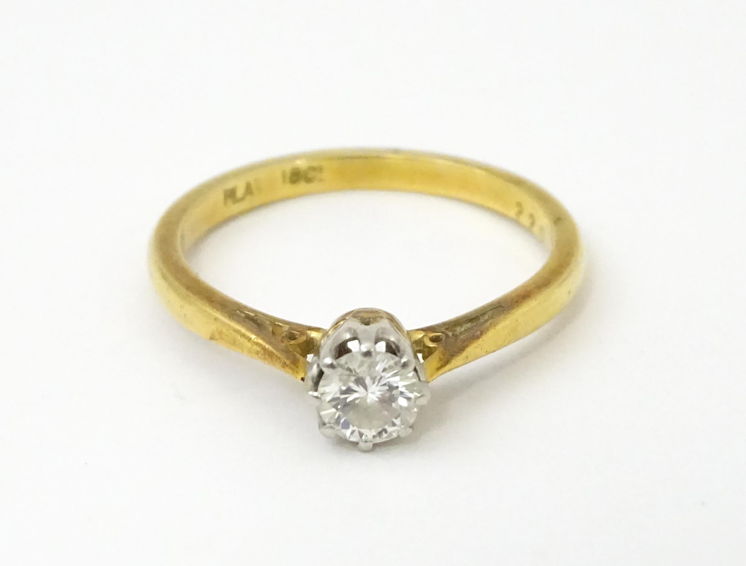 An 18ct gold ring set with diamond solitaire. Ring size approx. M 1/2 Please Note - we do not make