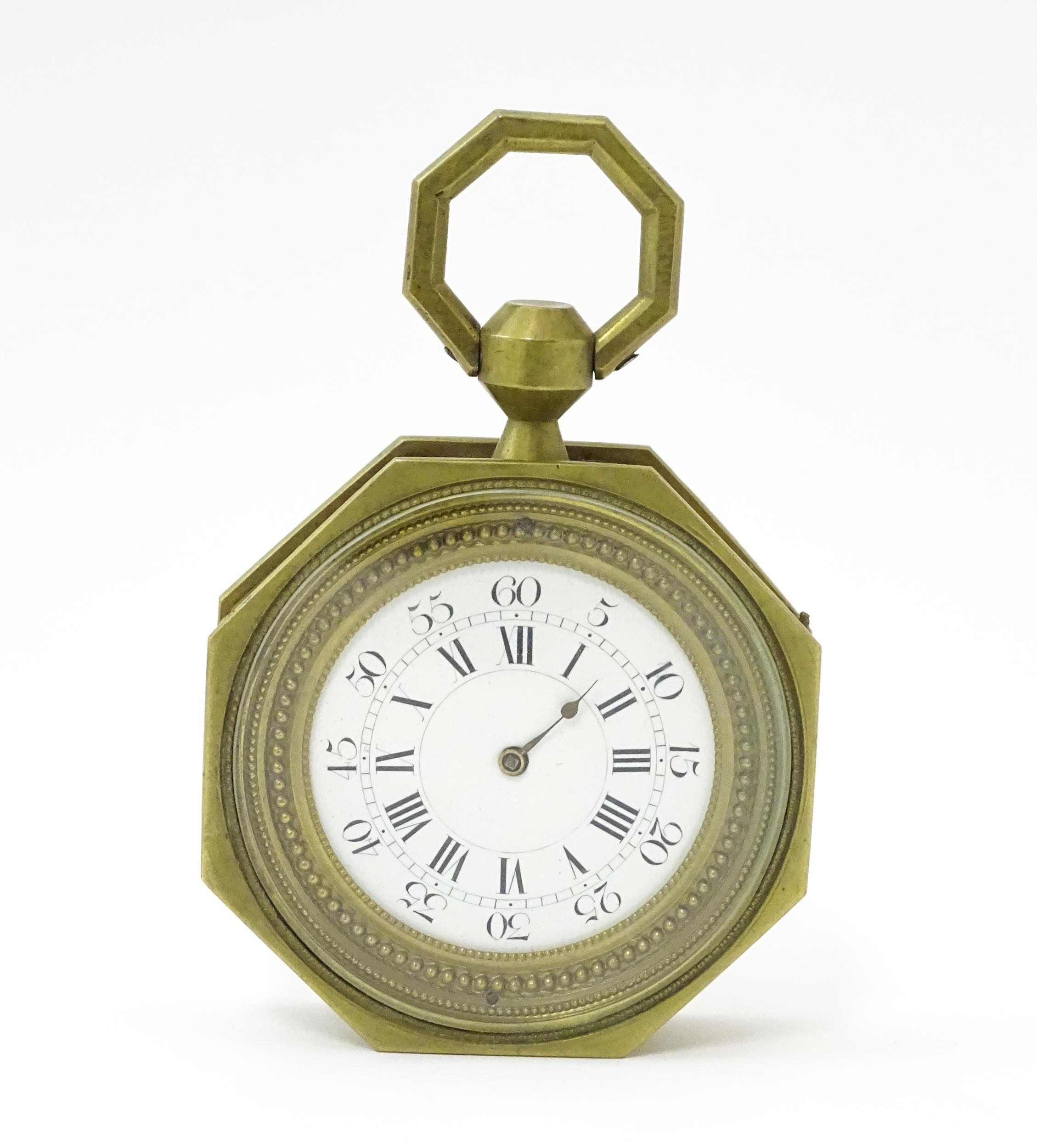 A brass cased hanging sedan style clock of octagonal form, with Roman hours and Arabic seconds.
