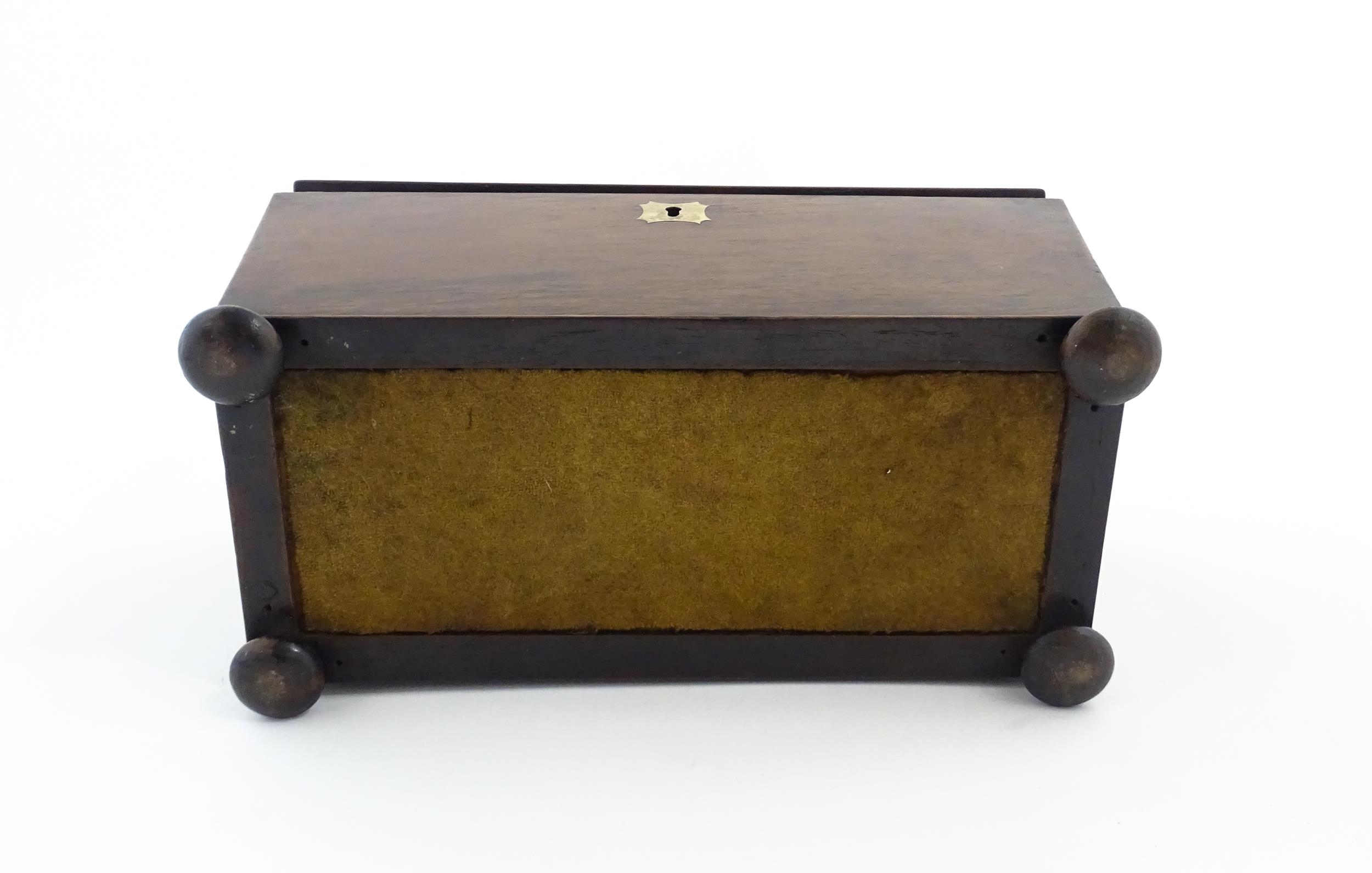 A 19thC rosewood tea caddy of sarcophagus form with four squat bun feet. The interior with two - Image 7 of 15