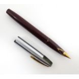 A Sheaffer 440XG fountain pen, with maroon barrel, steel cap and 14ct gold nib, approx 5 1/8" long