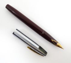 A Sheaffer 440XG fountain pen, with maroon barrel, steel cap and 14ct gold nib, approx 5 1/8" long