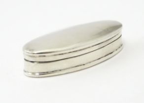 A small silver / white metal box of oval form 2" wide Please Note - we do not make reference to