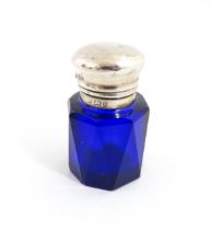 A blue glass scent / salts bottle with silver top hallmarked Birmingham 1902, maker Cornelius
