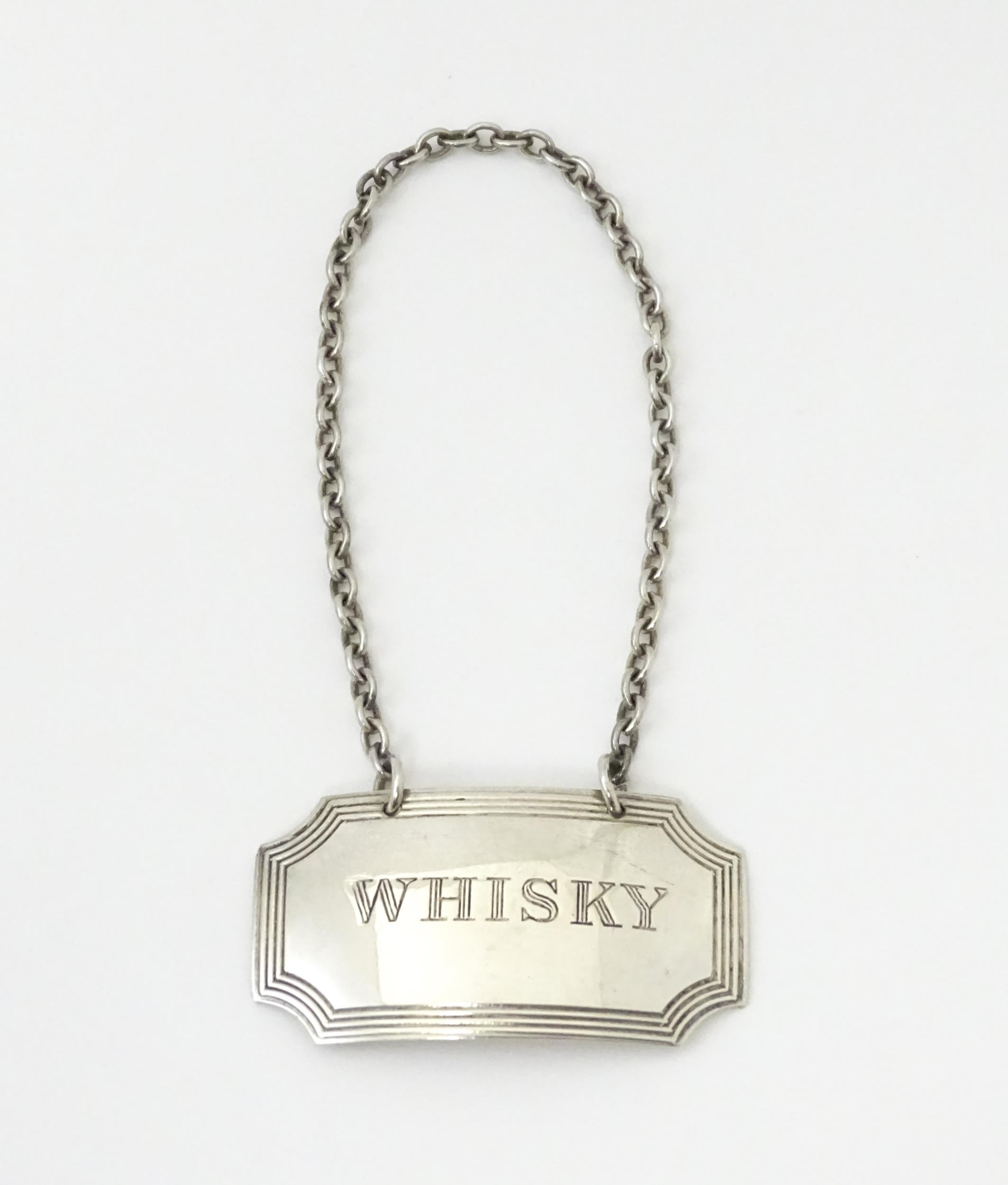 A silver wine / decanter label / bottle ticket engraved 'Whisky' and hallmarked Birmingham 1968,