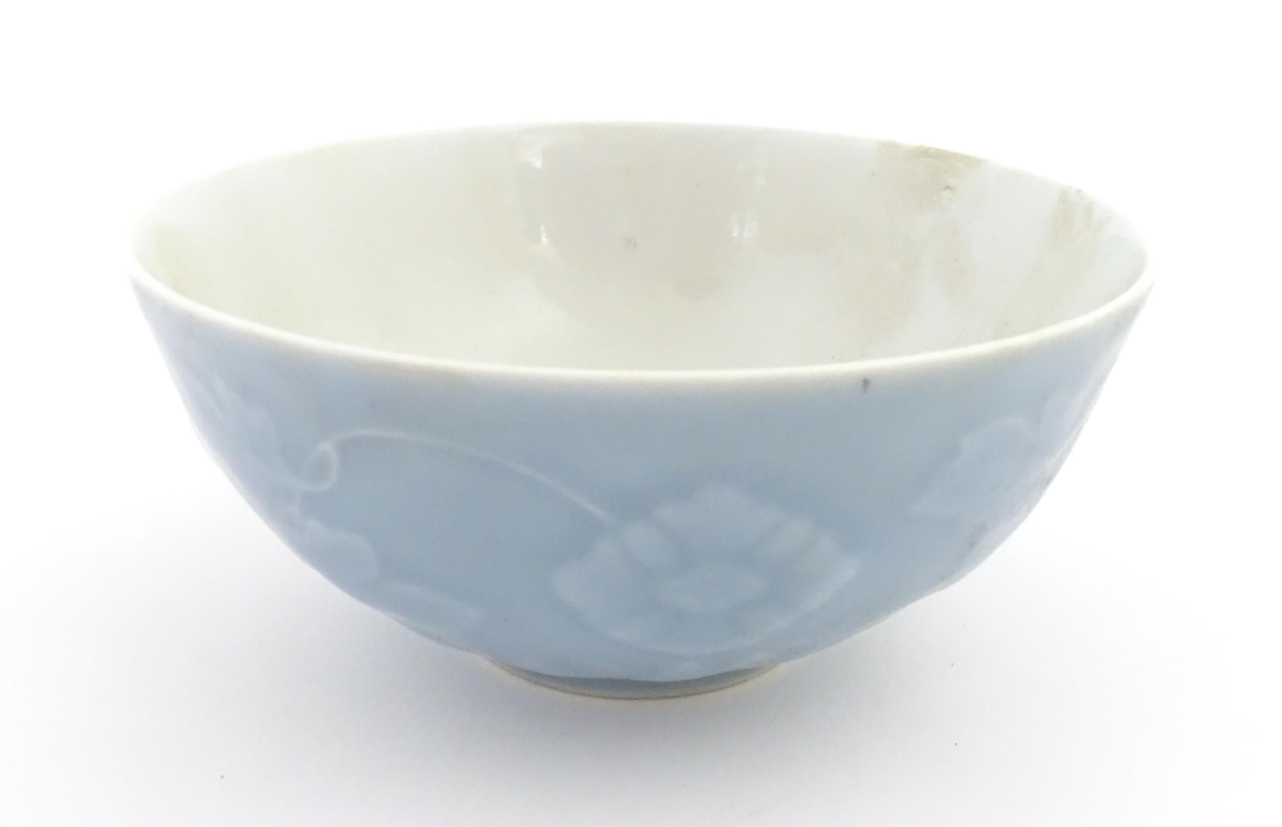 A Chinese bowl with a blue ground decorated with flowers and petals. Character marks under.