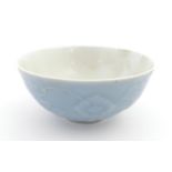 A Chinese bowl with a blue ground decorated with flowers and petals. Character marks under.