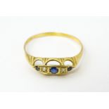 A gold ring set with diamonds and sapphires. Ring size approx. X Please Note - we do not make