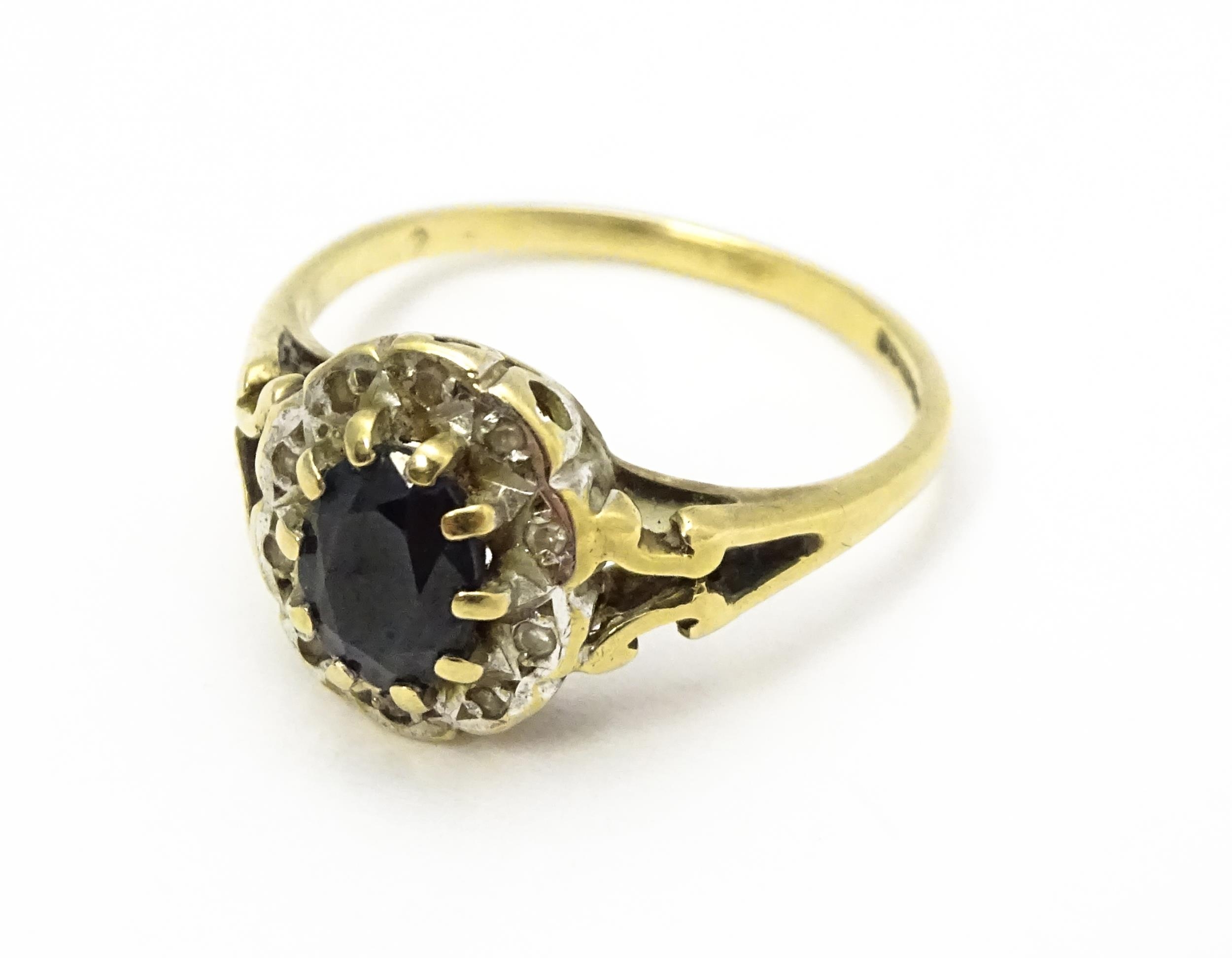 A 9ct gold ring set with central sapphire bordered by diamonds. Ring size approx. L 1/2 Please - Image 6 of 10