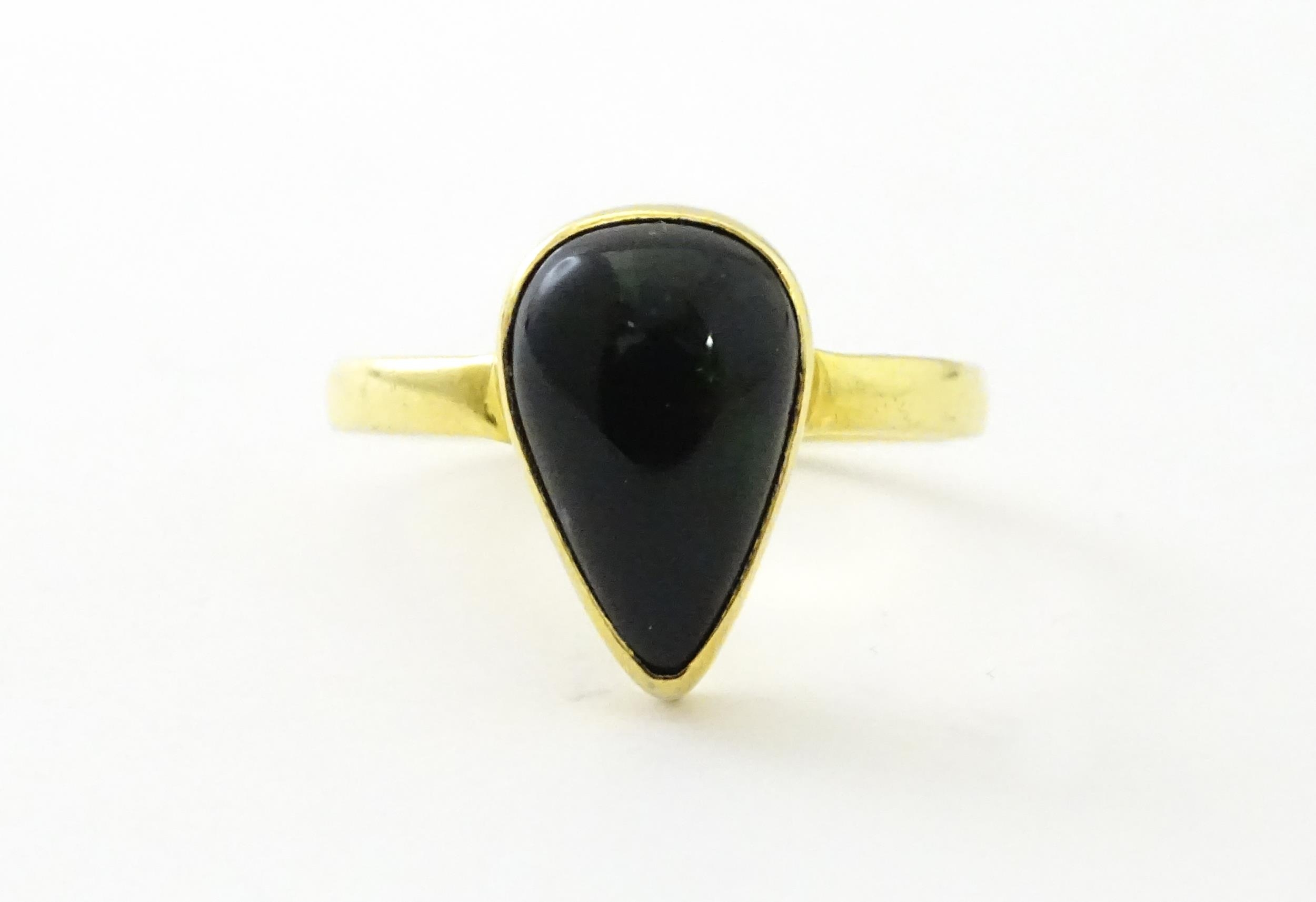 A silver gilt ring set with black opal style cabochon. Ring size approx. O. Please Note - we do - Image 3 of 6