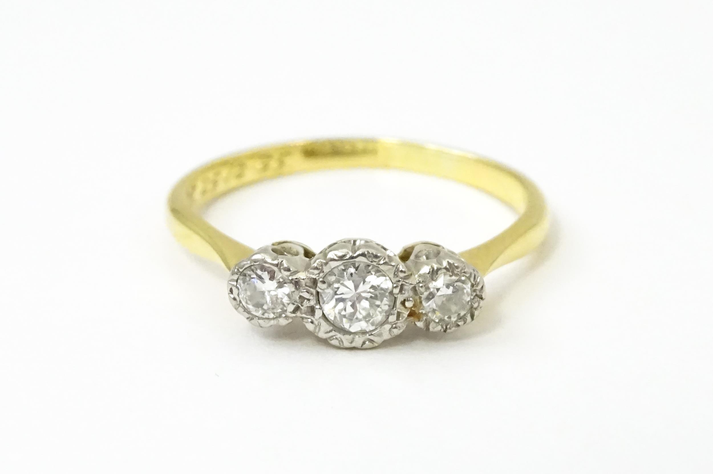 An 18ct gold ring with three platinum set diamonds. Ring size approx. O Please Note - we do not make - Image 5 of 18