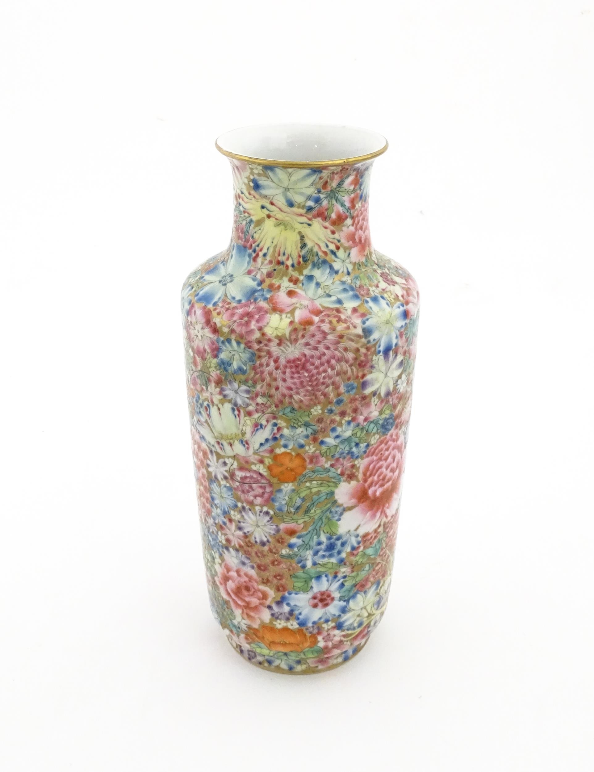 A Chinese famille rose vase decorated with a profusion of flowers. Character marks under. Approx. 10 - Image 3 of 6