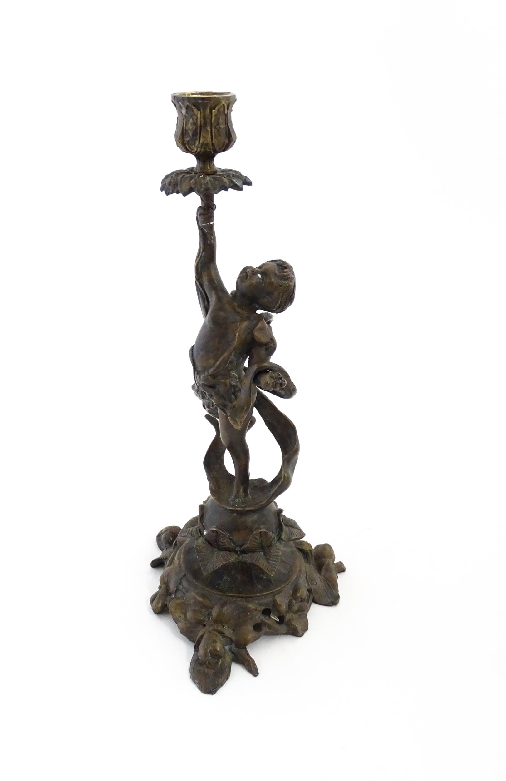 An early 20thC cast candlestick modelled as a winged putto / cherub holding aloft a sconce with - Image 3 of 6