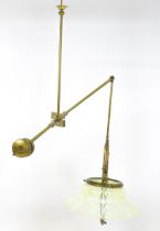 An Art Nouveau brass adjustable counter balance ceiling light with large flared vaseline glass