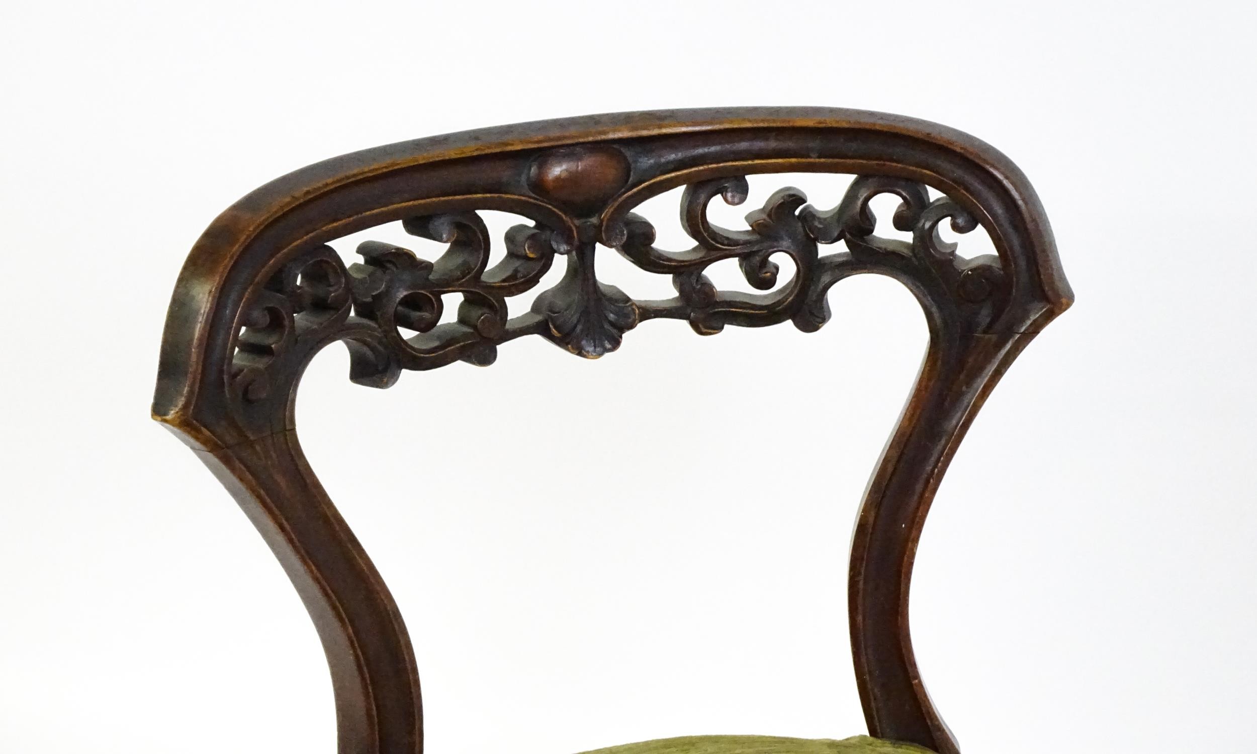A mid / late 19thC mahogany nursing chair with a pierced, carved floral top rail above moulded - Image 2 of 6