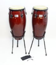 Musical Instruments : a pair of Millenium conga / tumba drums , with tripod stands and a tuning key,