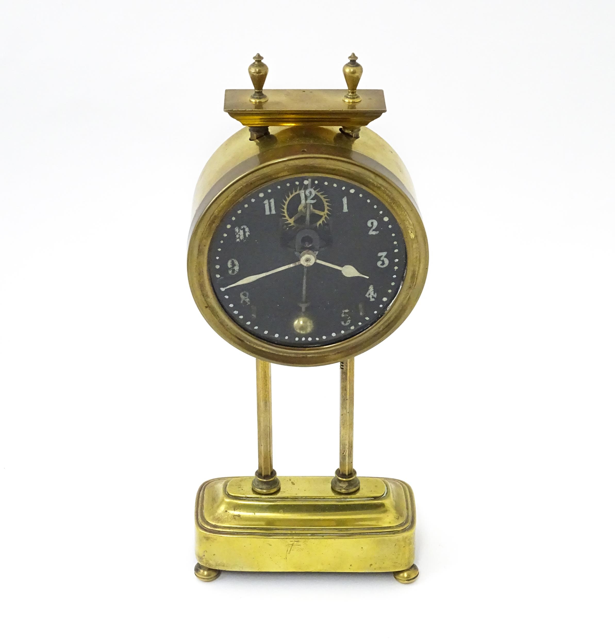 A brass cased Gravity clock with dial with Arabic numerals and having exposed escapement. Marked - Image 3 of 9