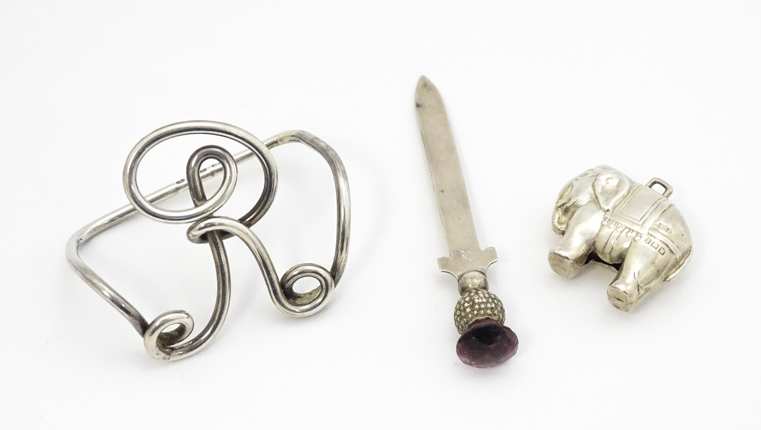 Three silver items comprising a small paper knife / bookmark with thistle finial hallmarked