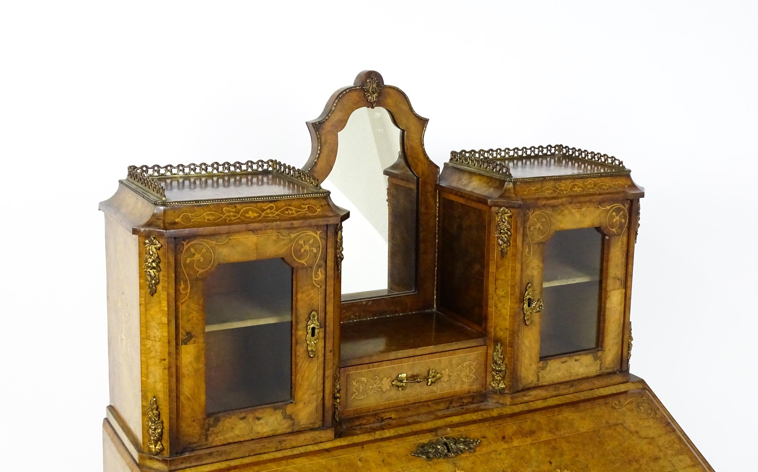 A 19thC burr walnut Bonheur du jour with a mirrored back stand and flanked by two glazed cabinets - Image 6 of 11