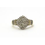 A 9ct gold cocktail ring set with a central cluster of diamonds flanked by further diamonds to