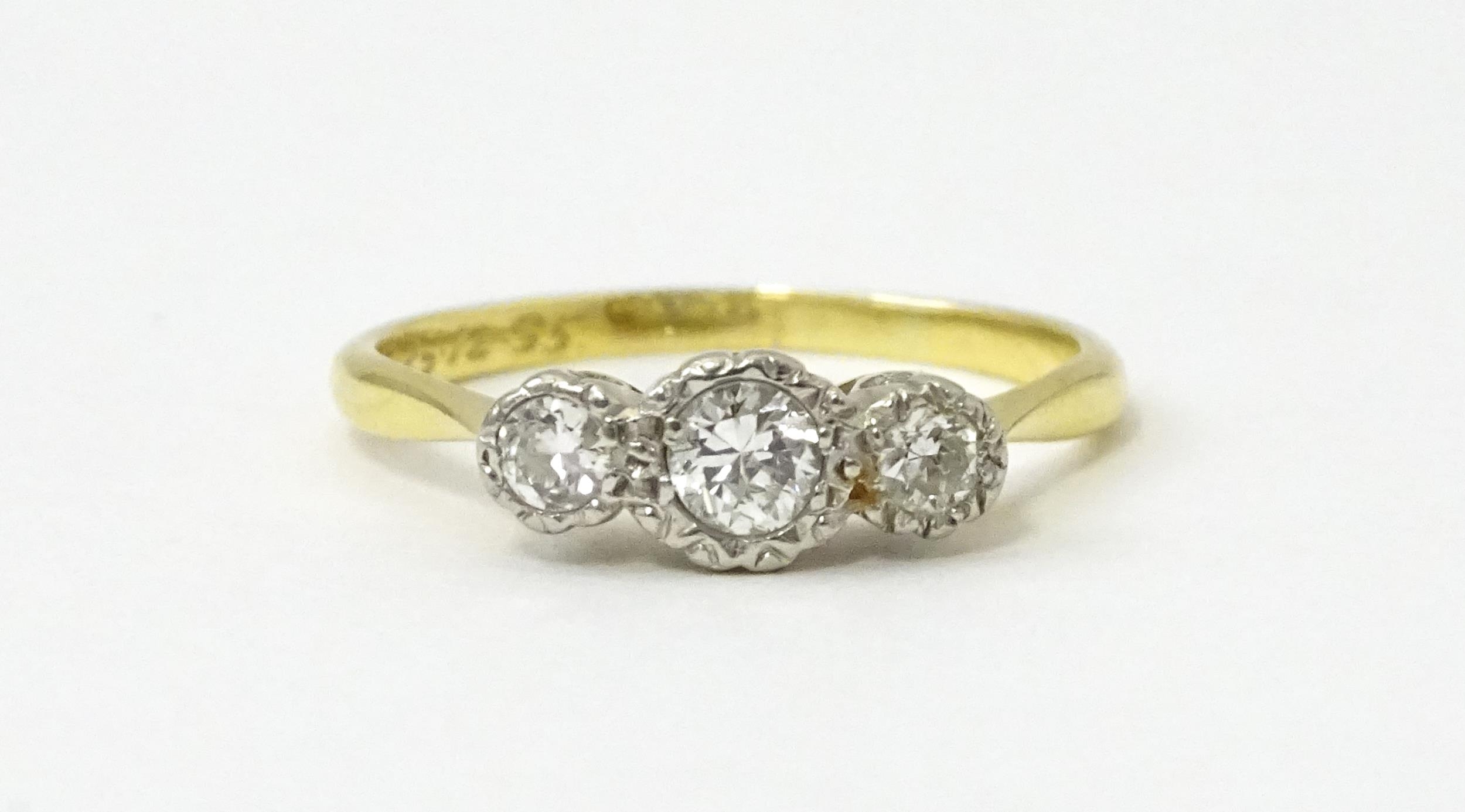 An 18ct gold ring with three platinum set diamonds. Ring size approx. O Please Note - we do not make - Image 2 of 18