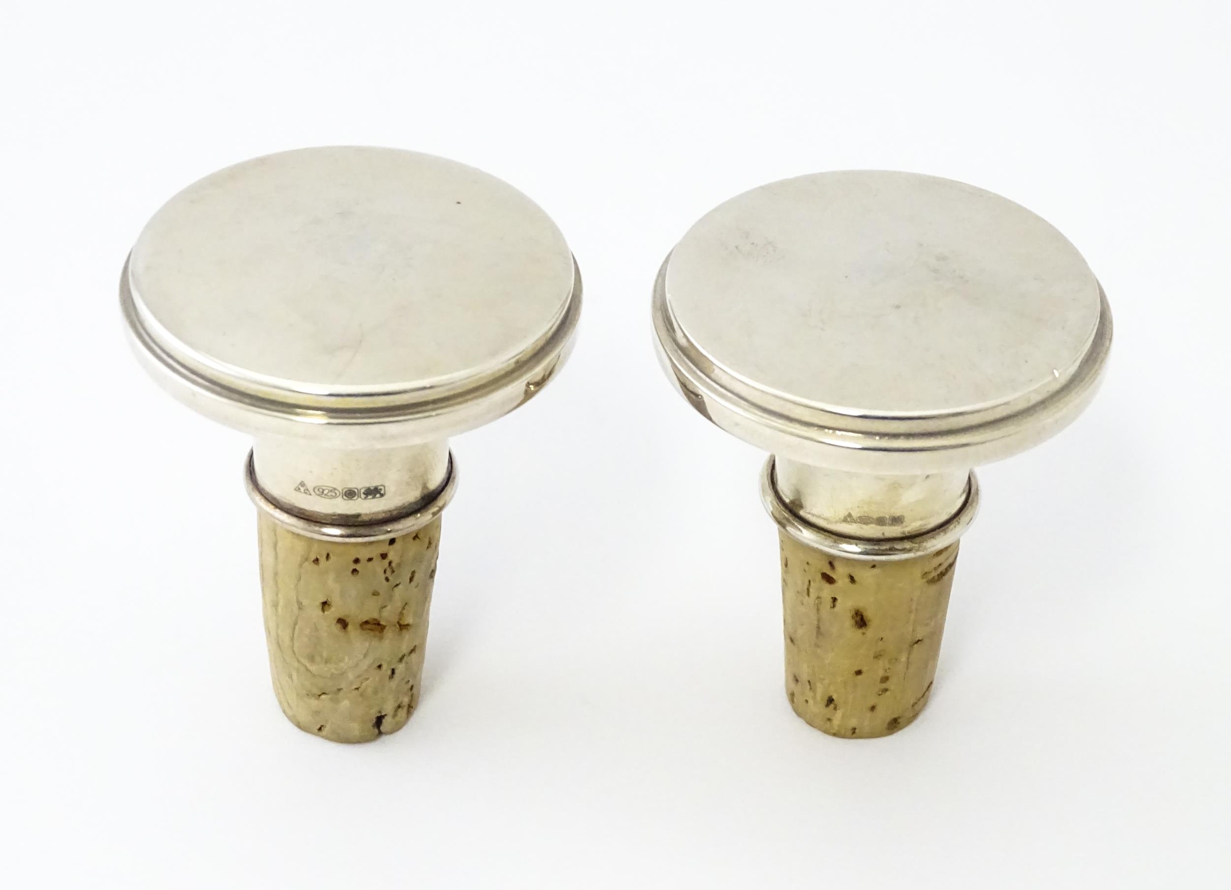 A pair of 21stC silver and cork bottle stoppers. Tops approx. 1 3/4" diameter (2) Please Note - we