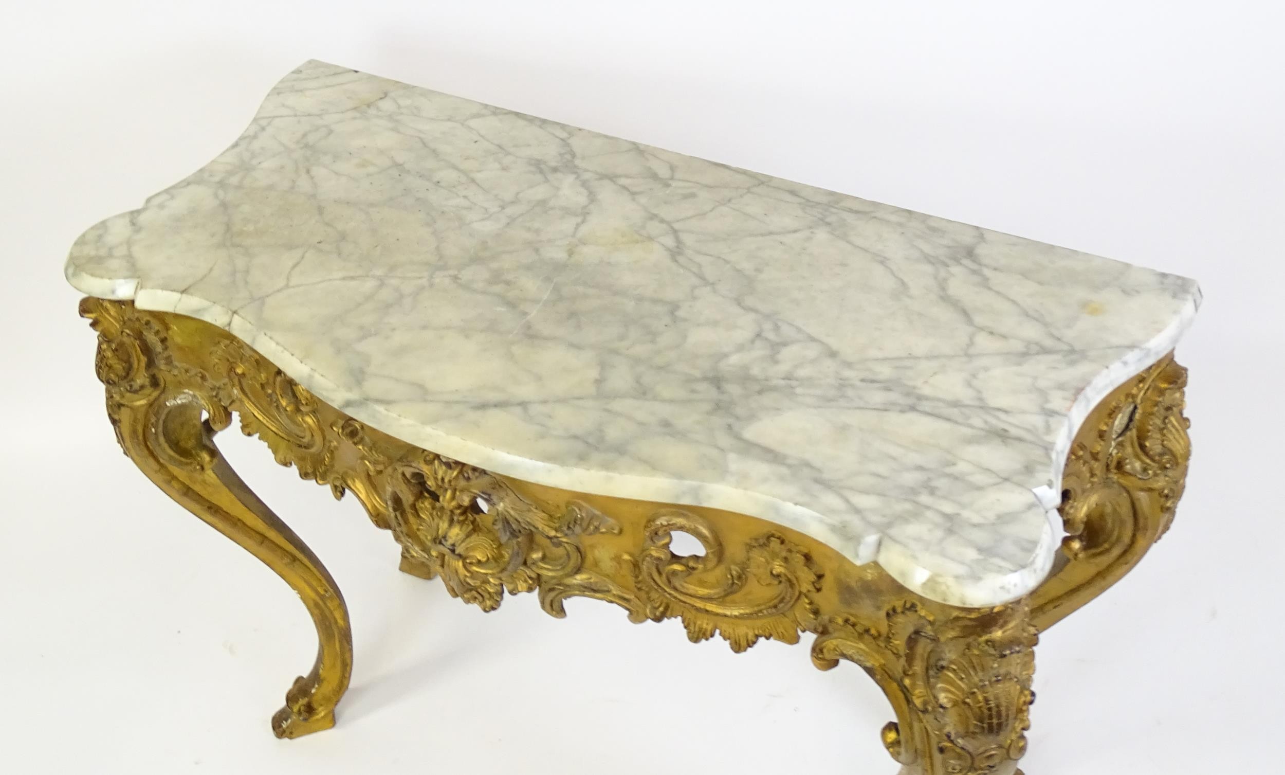 A 19thC marble topped table with a gesso and giltwood moulded base, decorated with shells, - Image 6 of 8