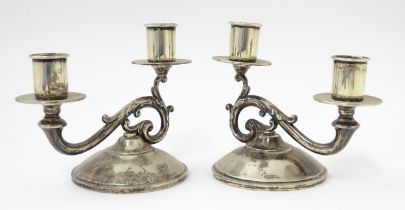 A pair of American silver twin branch candlesticks. Marked under Fisher Sterling. Approx 4 3/4" high