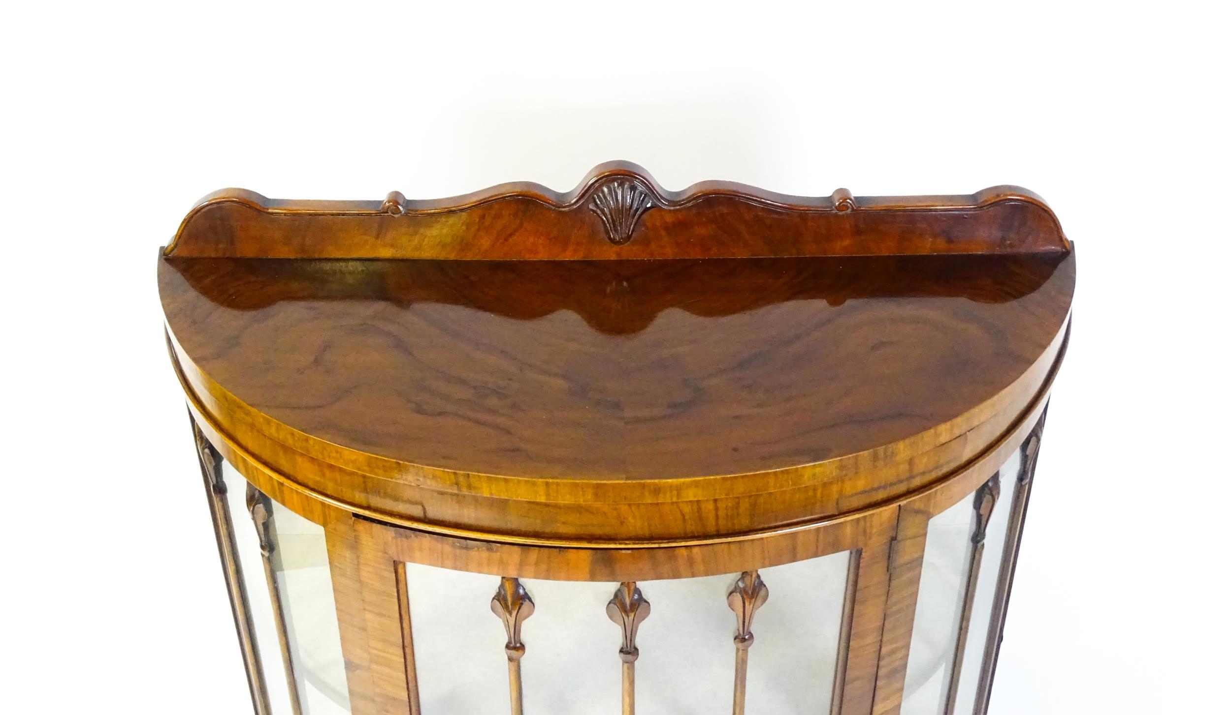 An early / mid 20thC walnut demi lune display cabinet with a shaped and carved upstand above a - Image 6 of 8