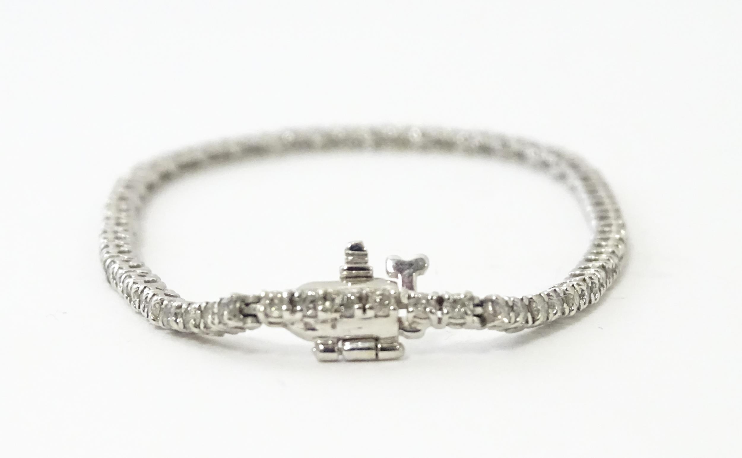 A 14ct white gold tennis bracelet set with diamonds. Approx 7 1/2" long Please Note - we do not make - Image 4 of 10