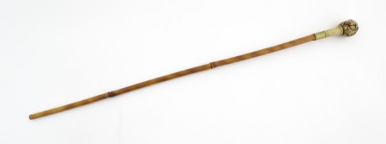 An early 20thC bamboo sword stick / cane with carved resin pommel depicting Oriental figures.