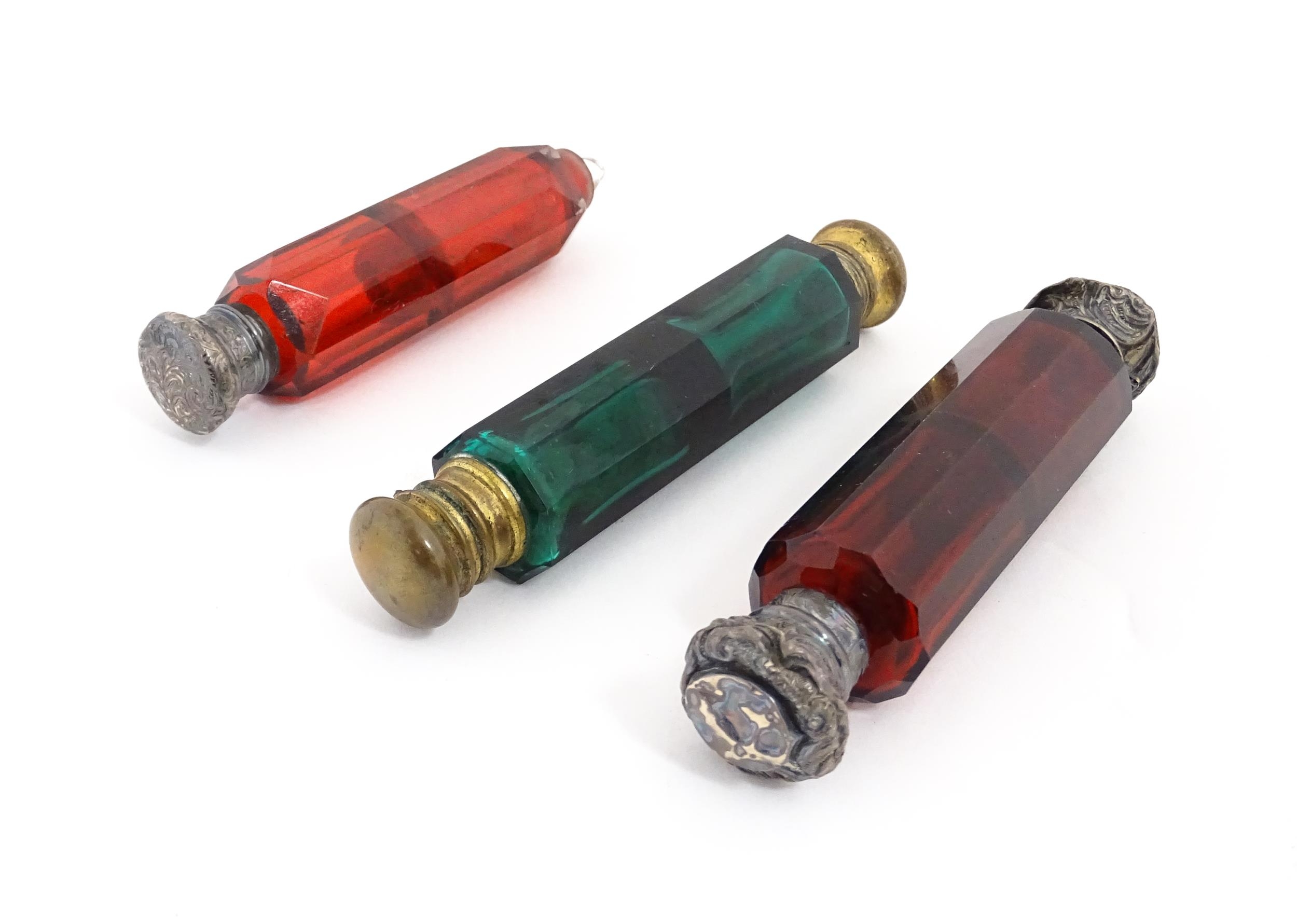 Three various Victorian double ended scent flasks compromising two ruby glass and a green glass