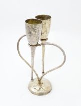 A pair of silver plate champagne flutes supported by a heart shaped base. Marked under Culinary