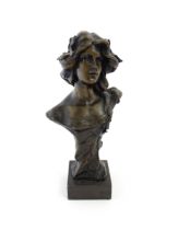 A 20thC cast bust depicting an young lady in the Art Nouveau style after Emmanuel Villanis.