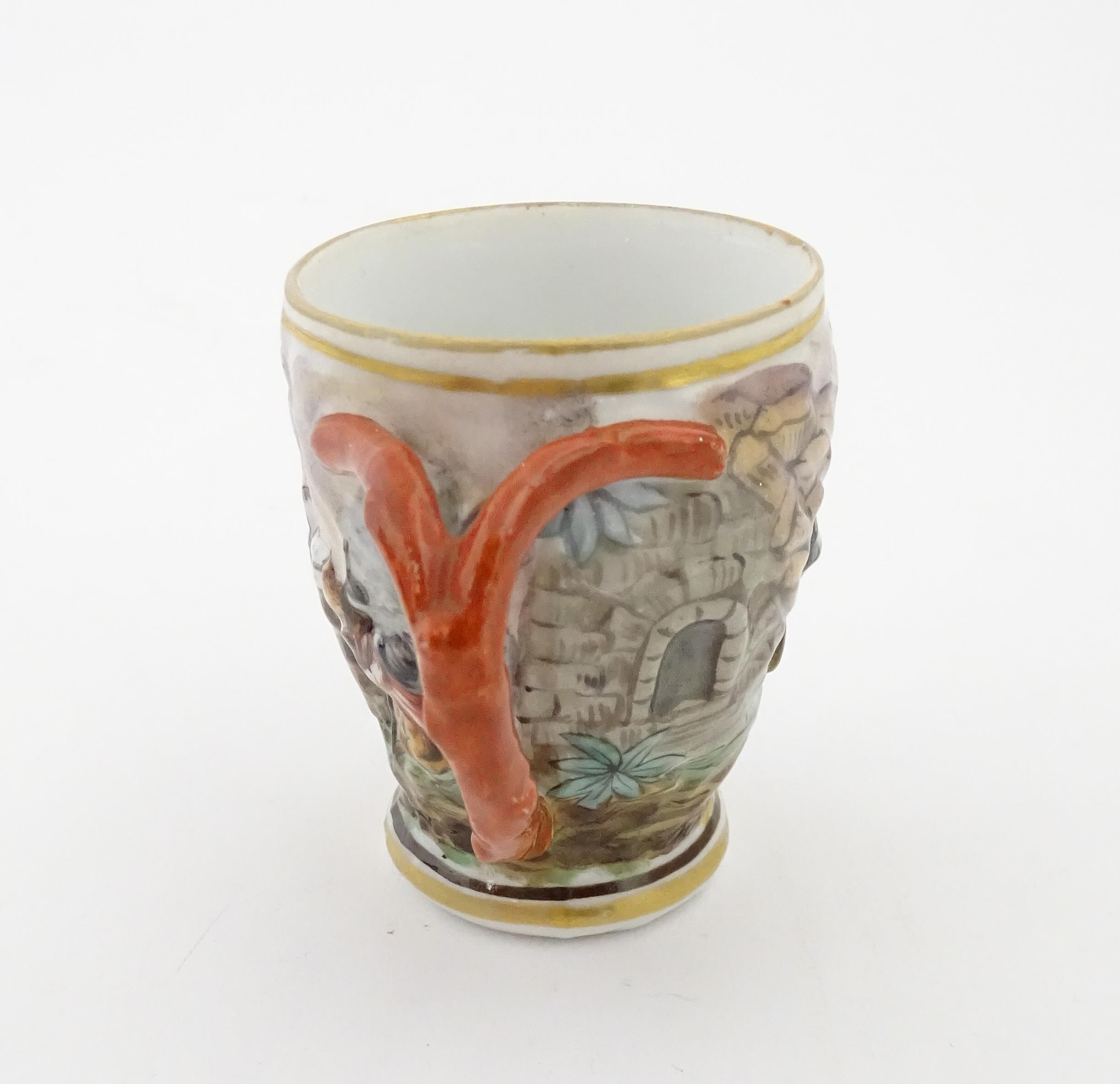 A Continental coffee cup decorated in relief with animals in a landscape. Marked under with - Image 5 of 6