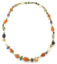 A bead necklace with various hardstone beads. Approx 26" long Please Note - we do not make reference