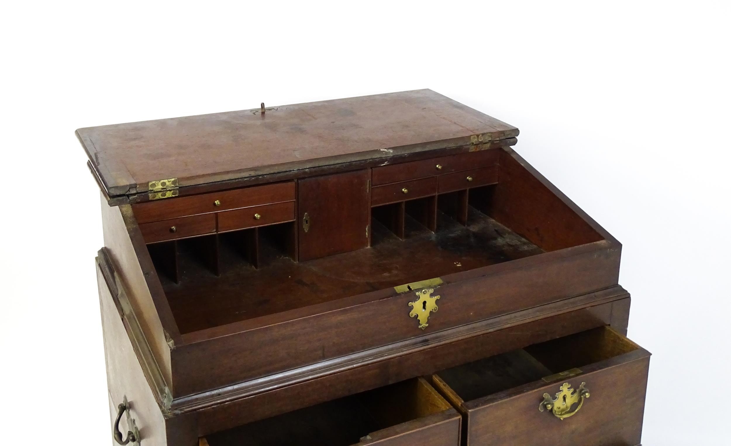 An early / mid 18thC mahogany clerks desk with a hinged sloping lid opening to show a fitted - Image 4 of 8
