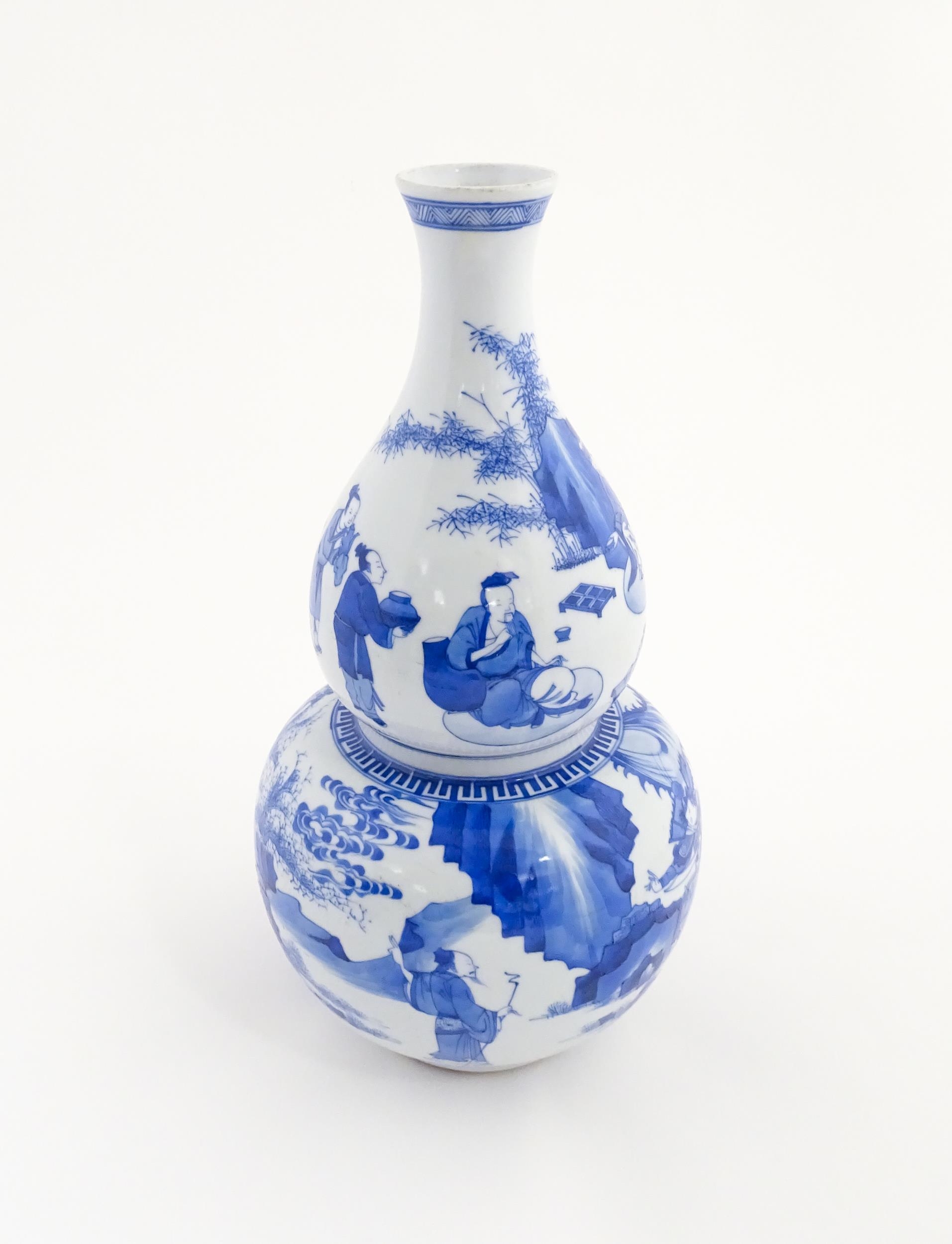 A Chinese blue and white double gourd vase decorated with figures in a landscape. Approx. 16 1/4" - Image 6 of 7