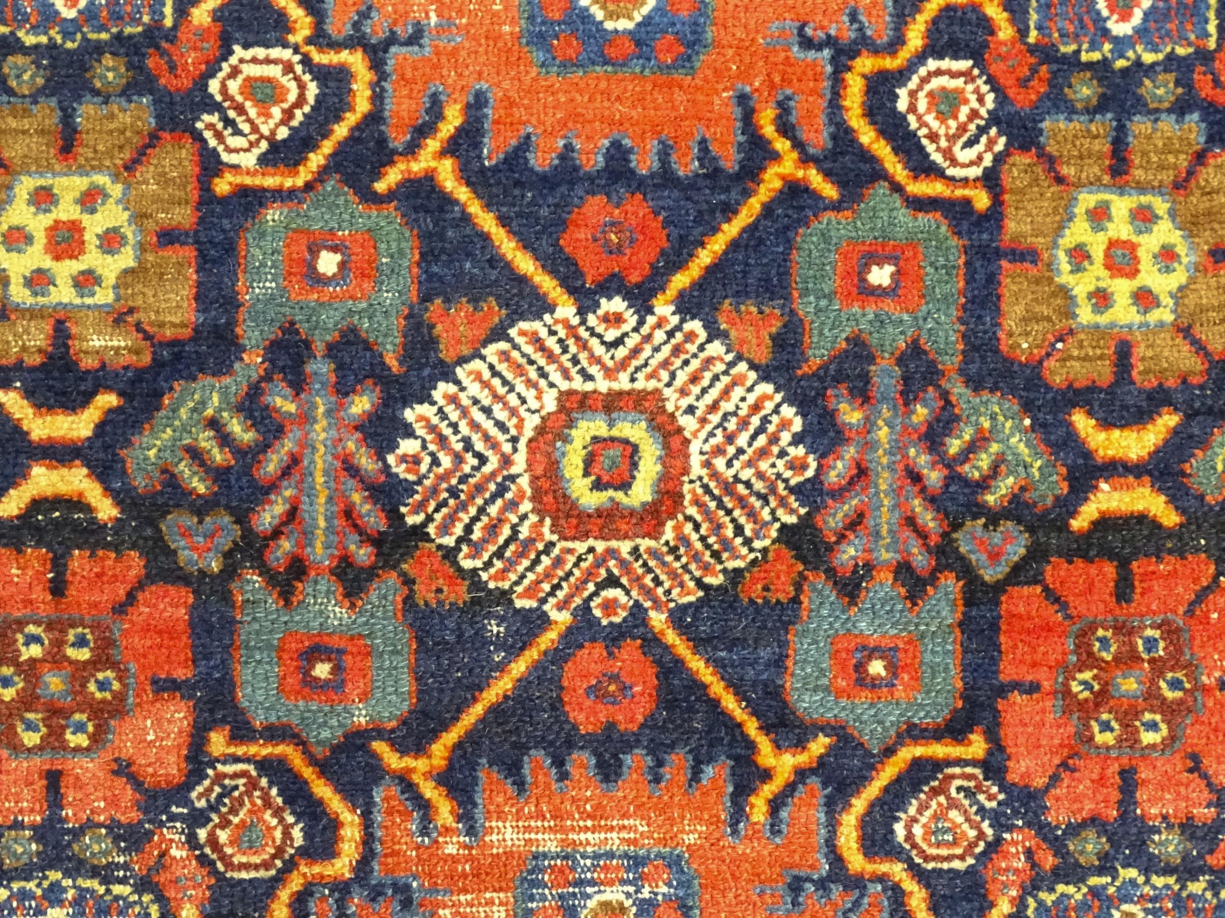 Carpet / Rug: A blue ground rug decorated with repeating geometric motifs of stylised floral and - Image 6 of 8